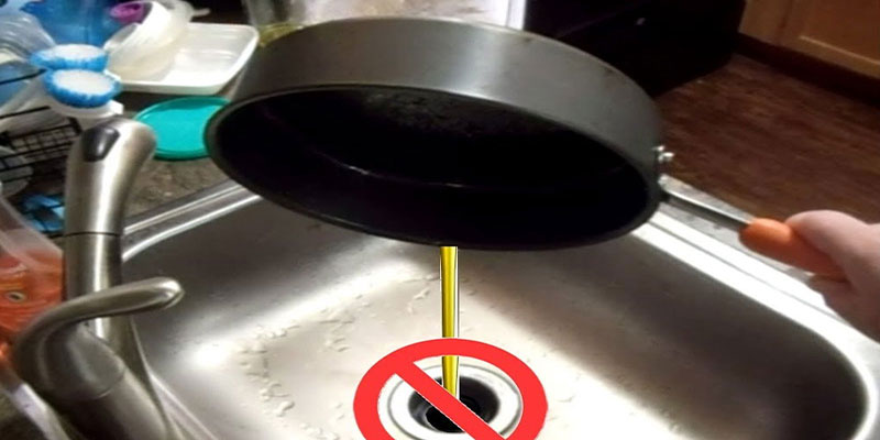 pouring oil down kitchen sink